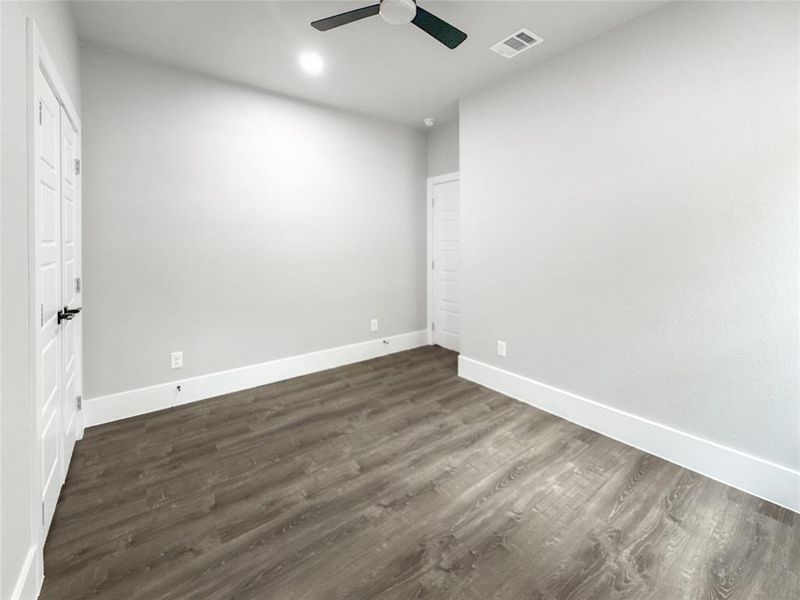 Unfurnished bedroom featuring dark wood finished floors, ceiling fan, and recessed lighting