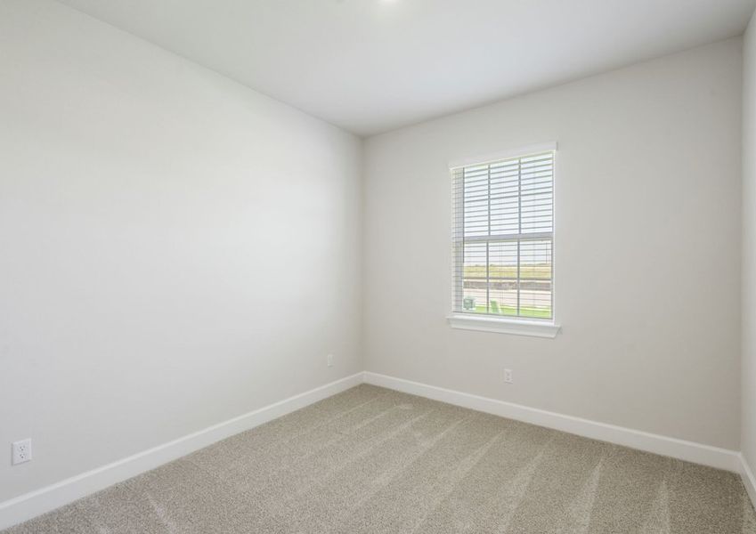 Secondary bedroom with lush carpet flooring