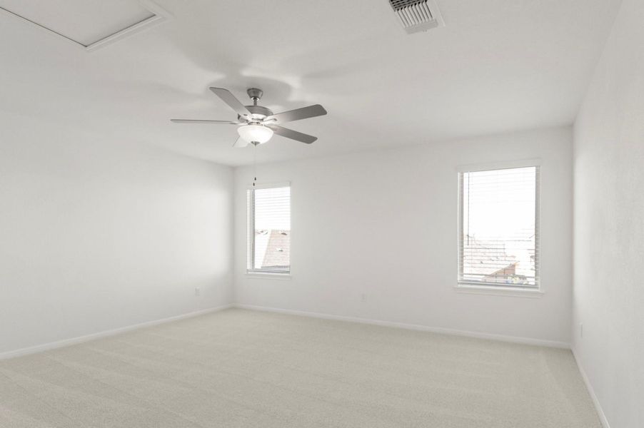 Spare room with light carpet and ceiling fan
