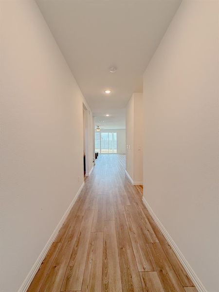 Hall featuring light wood finished floors and baseboards