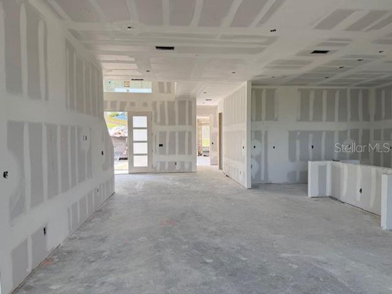 From back patio to the front door and garage door - kitchen to the right