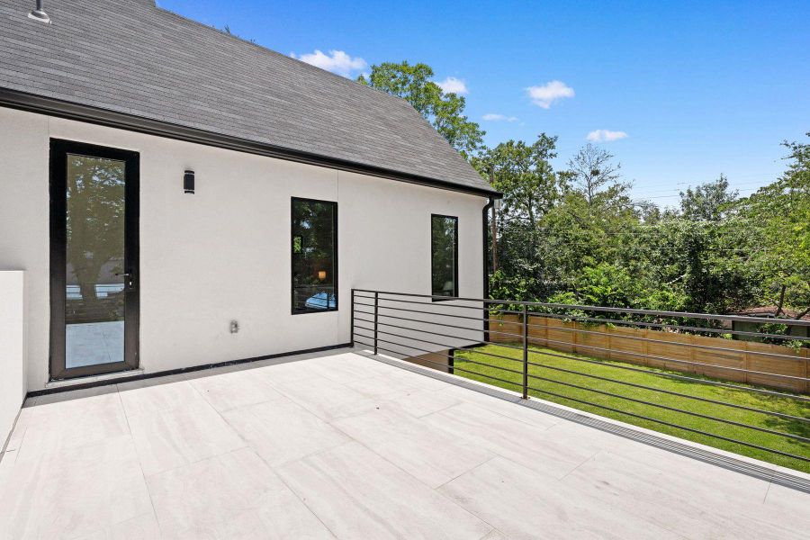 A spacious terrace features sleek black railings and a pristine tiled floor, perfect for outdoor enjoyment. A spacious terrace features sleek black railings and a pristine tiled floor, perfect for outdoor enjoyment.