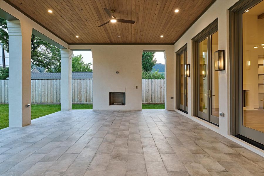 Expansive back porch off the living room offering an outdoor fire place and offering expanded space to enjoy.