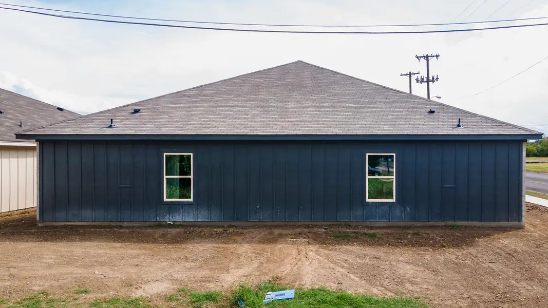 View of home's exterior with board and batten siding and a shingled roof