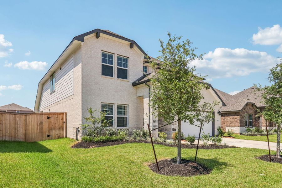 Front exterior of a new home in Kingdom Heights, Rosenberg, TX, highlighting curb appeal (Image 27). Front exterior of a new home in Kingdom Heights, Rosenberg, TX, highlighting curb appeal (Image 27).