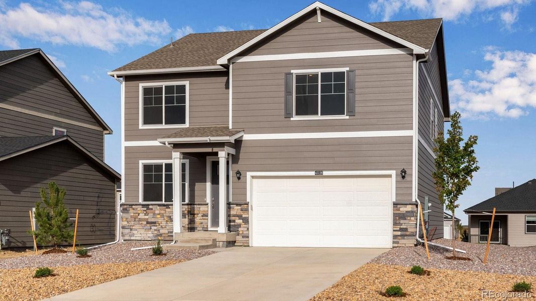 Front exterior of a new home in Spring Valley Ranch, Elizabeth, CO, highlighting curb appeal (Image 2).