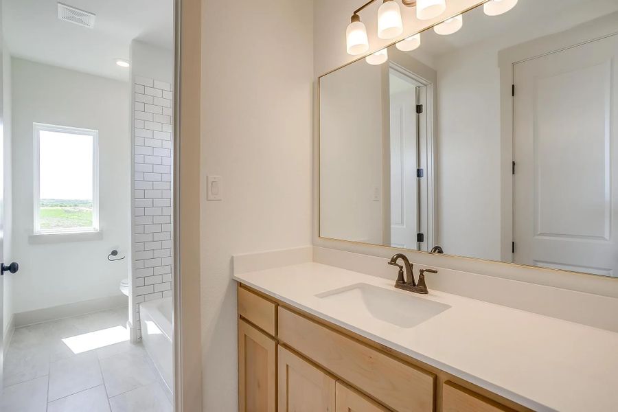 Representative furnished interior of a home built from the The Carley by Elmwood Custom Homes in Matthews Farm, Venus (Image 19).
