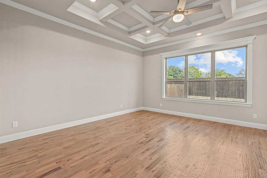Empty room featuring crown molding, light wood-style floors, beam ceiling, coffered ceiling, and recessed lighting