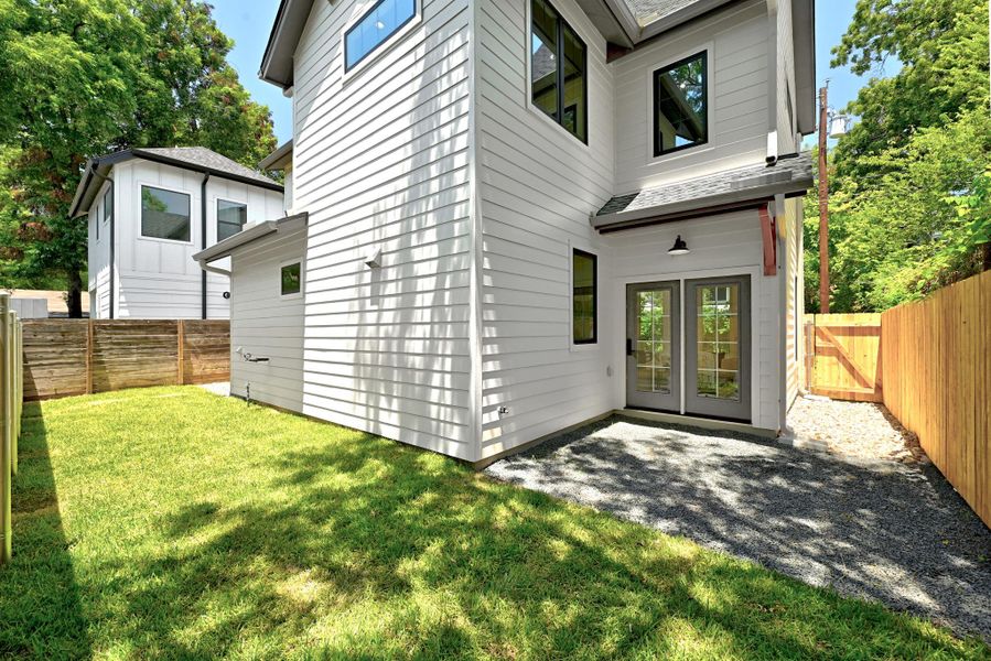 A well-maintained side yard and patio offer seamless indoor-outdoor living from this modern residence. A well-maintained side yard and patio offer seamless indoor-outdoor living from this modern residence.