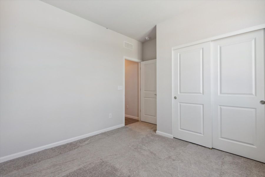 A hallway with white doors.