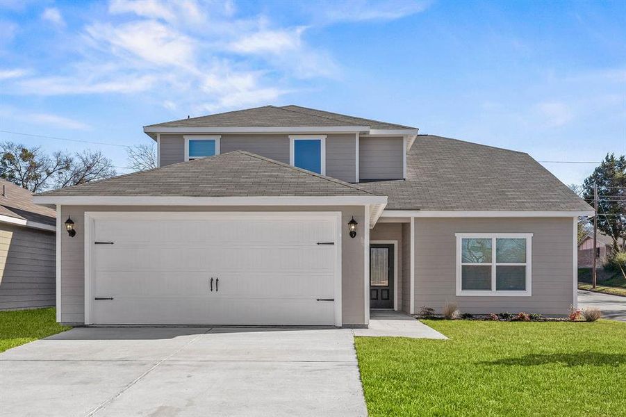 Front facade with a garage and a front yard