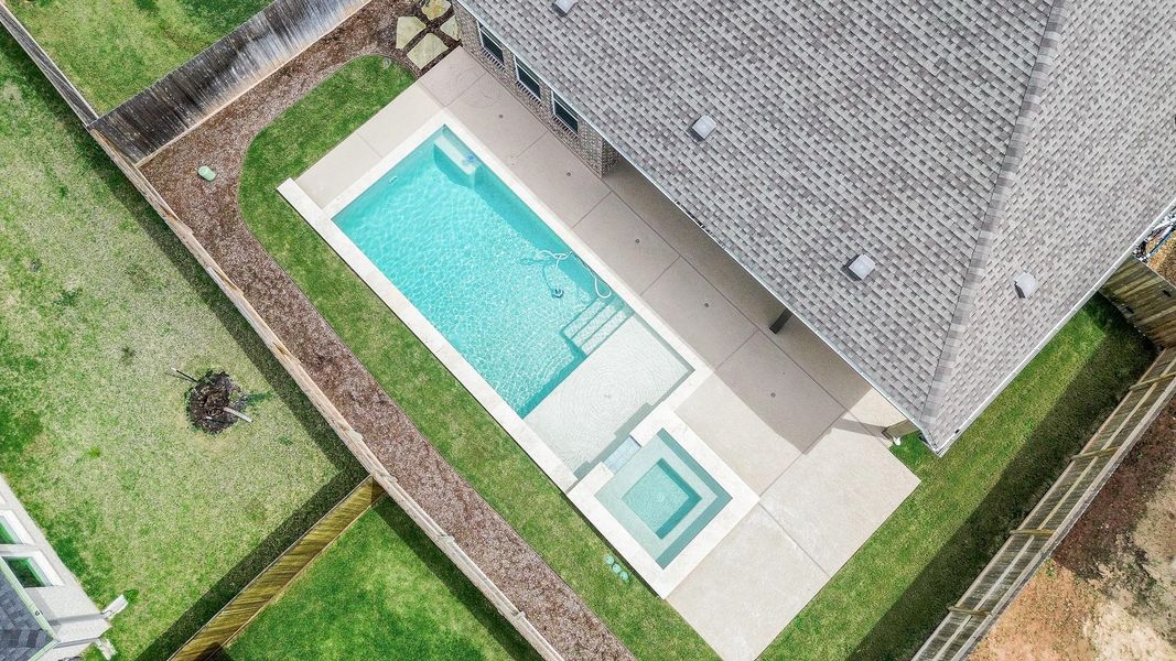 Great aerial shot of the salt water pool, lounging sun shelf and hot tub