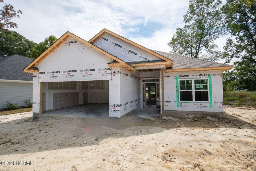 Front exterior of a new home in River Village Square in River Landing, Wallace, NC, highlighting curb appeal (Image 1).