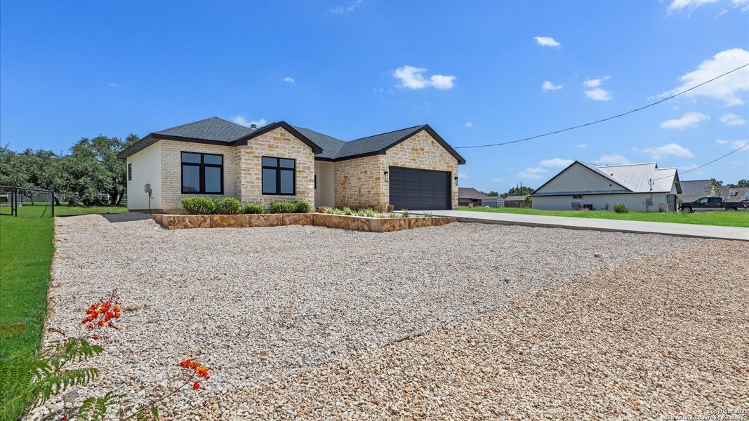 Front exterior of a new home in , Blanco, TX, highlighting curb appeal (Image 26).