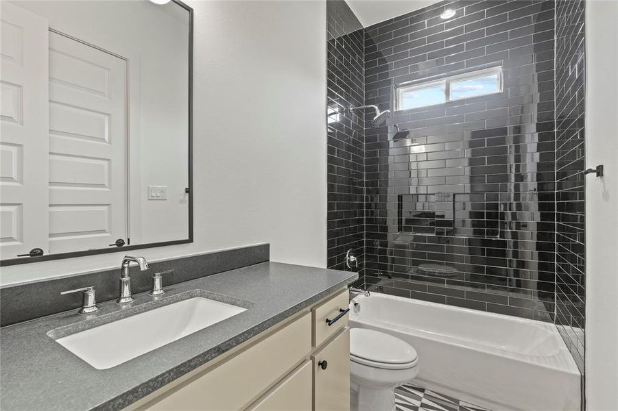 Full bathroom with bathing tub / shower combination and vanity Full bathroom with bathing tub / shower combination and vanity