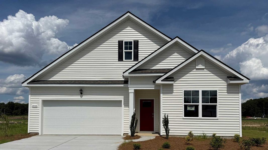 Front exterior of a new home in Meadow Walk, Loris, SC, highlighting curb appeal (Image 1). Front exterior of a new home in Meadow Walk, Loris, SC, highlighting curb appeal (Image 1).