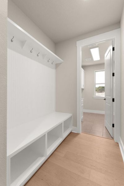 Mudroom with light wood-type flooring and baseboards