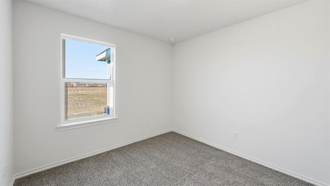 Carpeted empty room featuring baseboards Carpeted empty room featuring baseboards