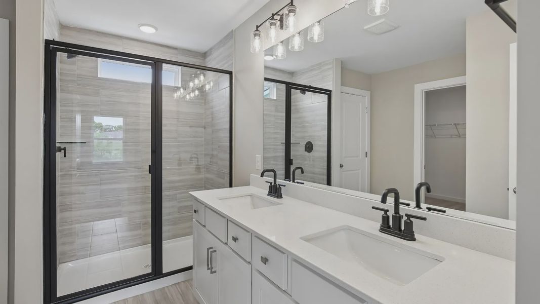 Bathroom with tile flooring and shower with glass enclosure, along with dual vanity Bathroom with tile flooring and shower with glass enclosure, along with dual vanity