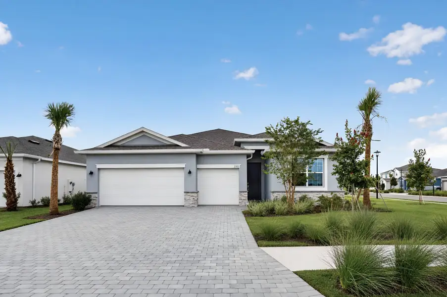 Front exterior of a new home in Rye Ranch, Parrish, FL, highlighting curb appeal (Image 1). Front exterior of a new home in Rye Ranch, Parrish, FL, highlighting curb appeal (Image 1).