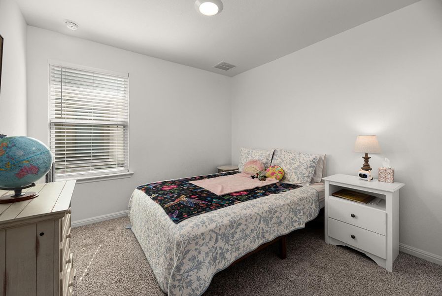 Bedroom with light colored carpet