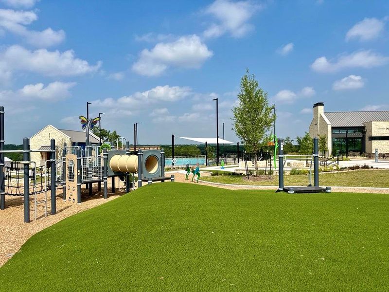An expansive outdoor recreational park is situated near modern stone community buildings. An expansive outdoor recreational park is situated near modern stone community buildings.