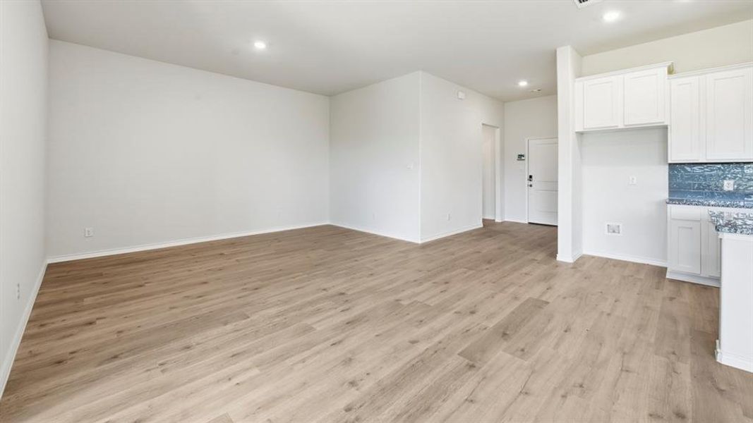 Unfurnished living room featuring light wood-type flooring and recessed lighting