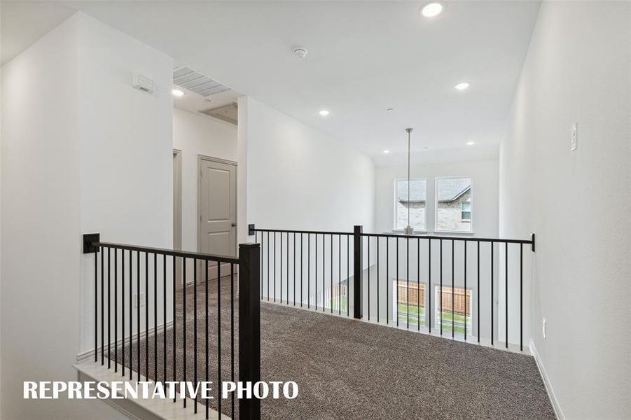 The loft area in our Baycliff plan features open railings that create a light filled space perfect for a reading nook or pocket office!  REPRESENTATIVE PHOTO