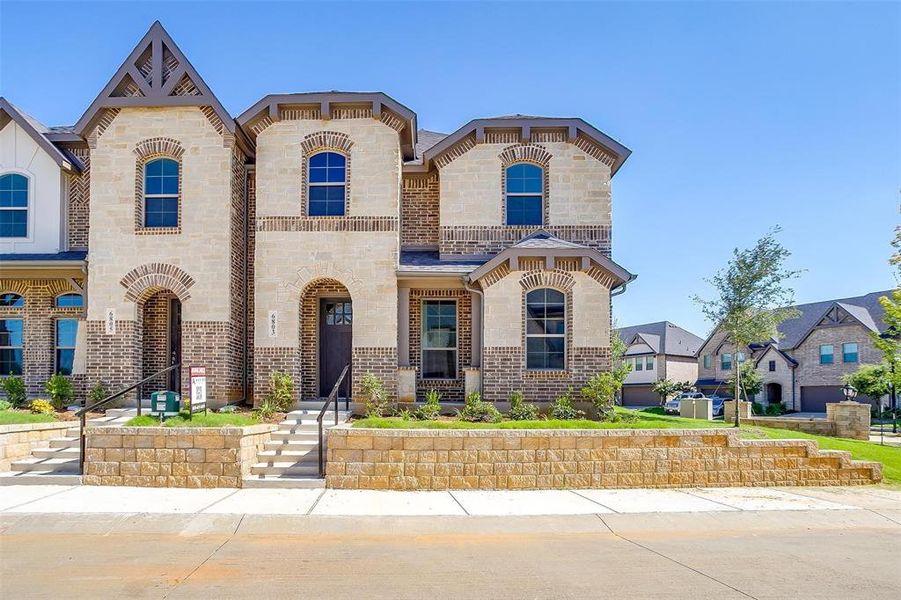 French provincial home with brick siding and stone siding French provincial home with brick siding and stone siding