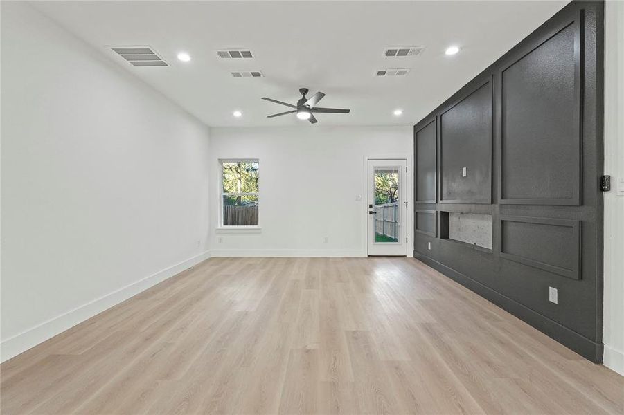 Unfurnished living room featuring recessed lighting, light wood finished floors, and a ceiling fan Unfurnished living room featuring recessed lighting, light wood finished floors, and a ceiling fan
