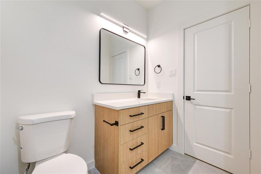 Secondary bathroom featuring Euro-style cabinets and contemporary finishes