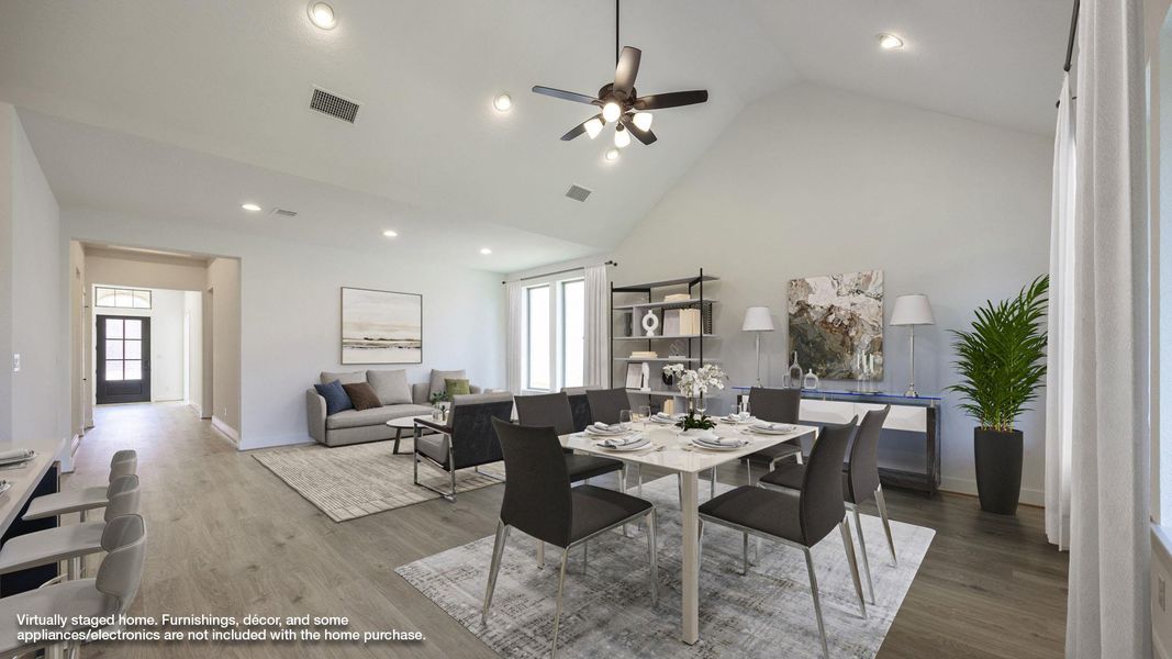 Dining area with high vaulted ceiling, wood finished floors, recessed lighting, and a ceiling fan