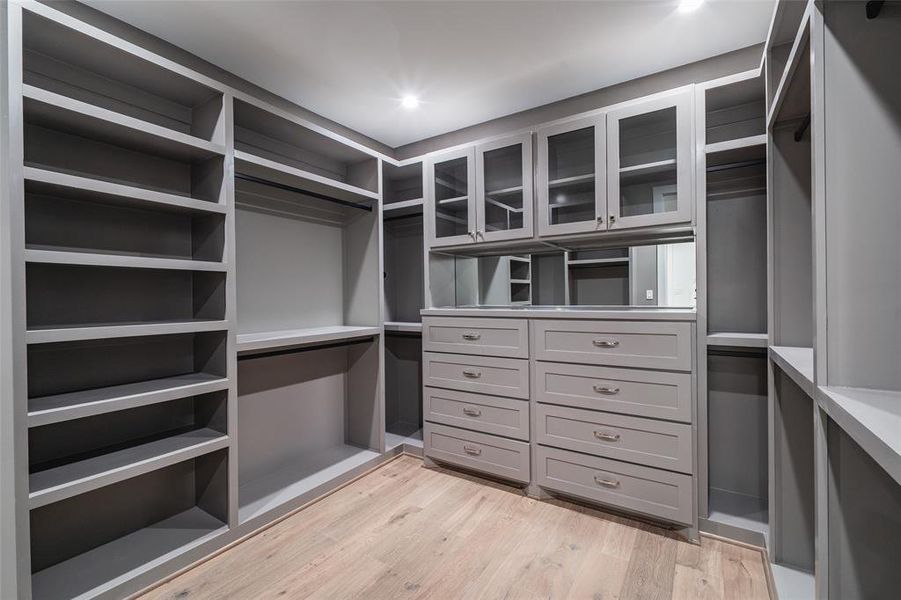 Walk in closet with light wood-type flooring