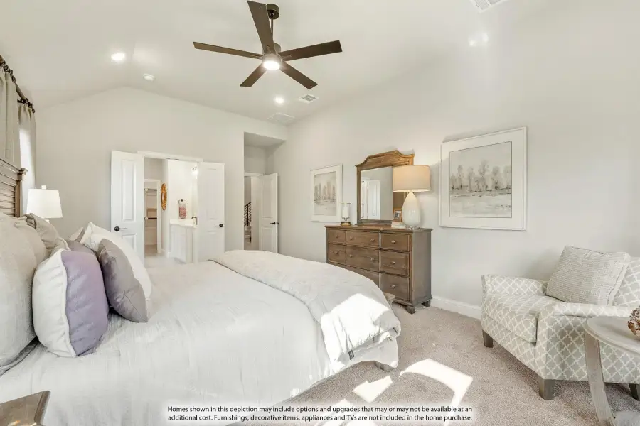 Master bedroom with vaulted ceiling, ceiling fan, carpet flooring, and ensuite bathroom access Master bedroom with vaulted ceiling, ceiling fan, carpet flooring, and ensuite bathroom access