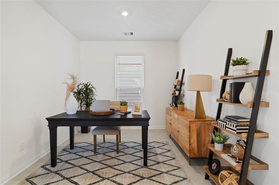 This den is the perfect spot for a home office! Featuring tile flooring, high ceilings, and a large window with privacy blinds.