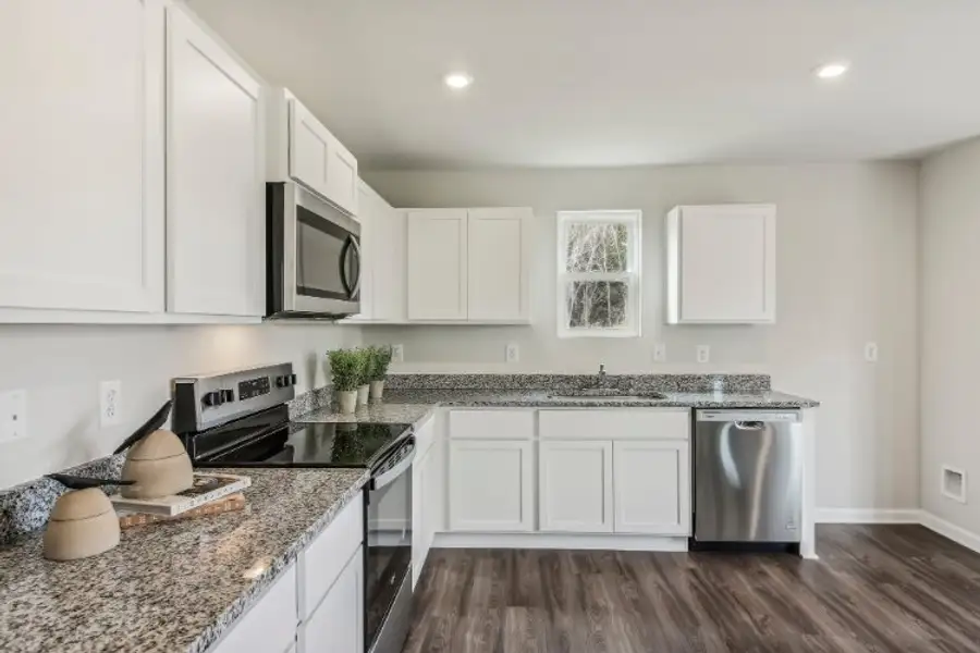 A kitchen with white cabinets. A kitchen with white cabinets.