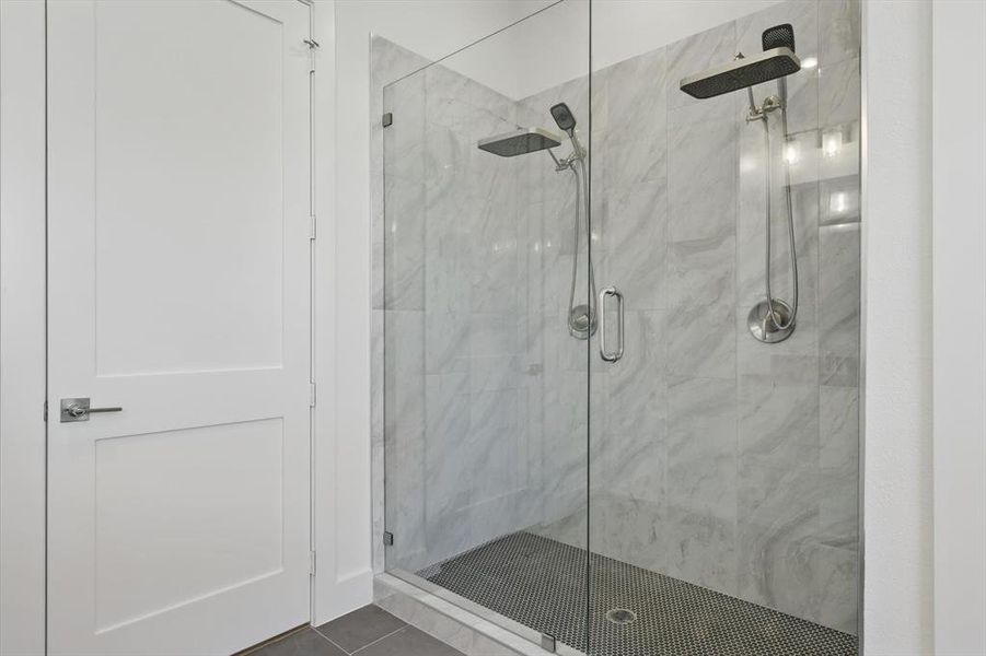 Full bathroom with a shower stall and tile patterned floors