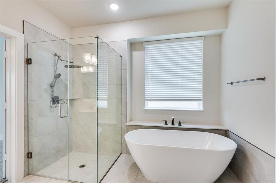 Bathroom featuring a shower stall and a freestanding tub Bathroom featuring a shower stall and a freestanding tub