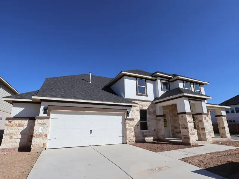 Front exterior of a new home in Barksdale, Leander, TX, highlighting curb appeal (Image 1). Front exterior of a new home in Barksdale, Leander, TX, highlighting curb appeal (Image 1).