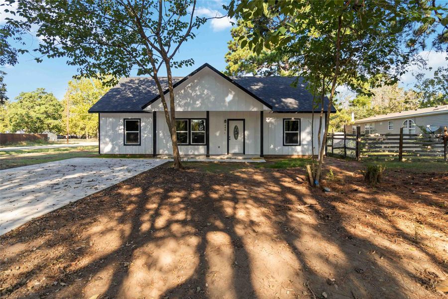 View of front of property featuring roof with shingles and covered porch