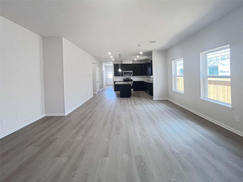 Family Room into Dining Area and Kitchen. Home under construction. Sample floor plan photo used for illustrative purposes only. Upgrades, selections options, windows and colors may vary.