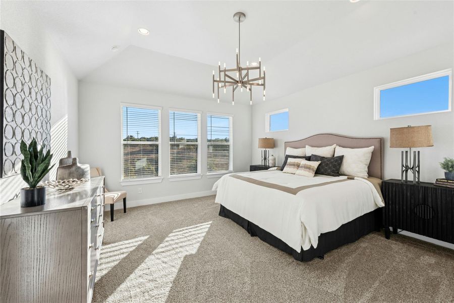 Carpeted bedroom featuring a chandelier, recessed lighting, and lofted ceiling Carpeted bedroom featuring a chandelier, recessed lighting, and lofted ceiling