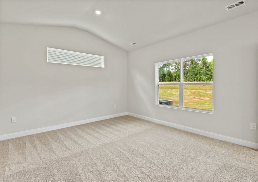 The master bedroom has lots of windows to let in natural light