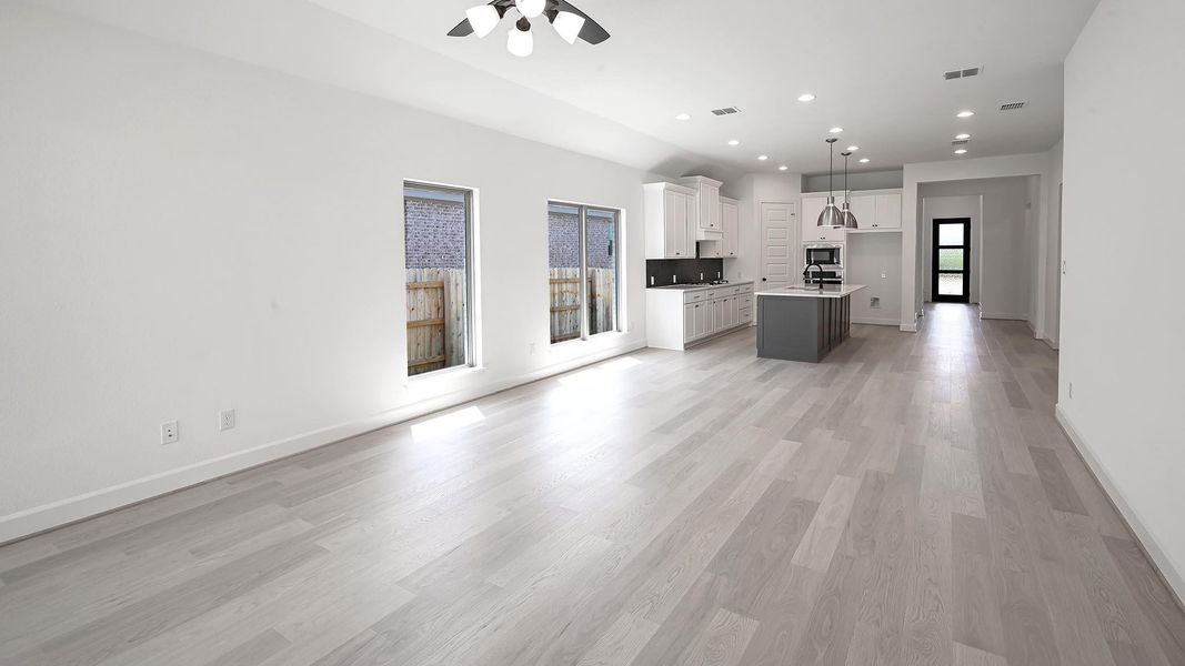Unfurnished living room with recessed lighting, light wood-type flooring, and ceiling fan Unfurnished living room with recessed lighting, light wood-type flooring, and ceiling fan