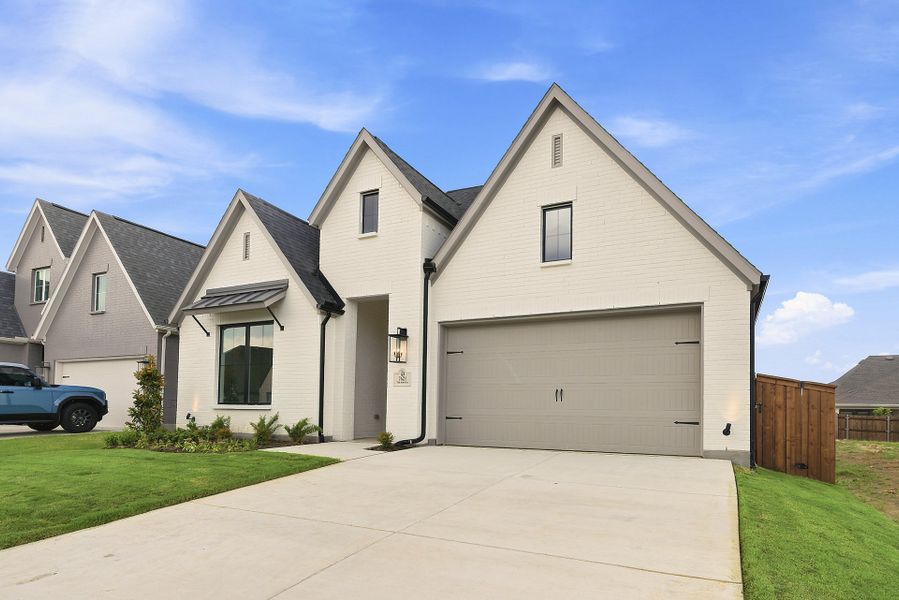 Front exterior of a new home in Tavolo Park, Fort Worth, TX, highlighting curb appeal (Image 22).