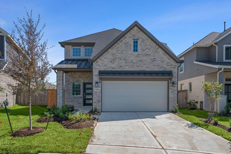 Front exterior of a new home in Emory Glen, Magnolia, TX, highlighting curb appeal (Image 2).