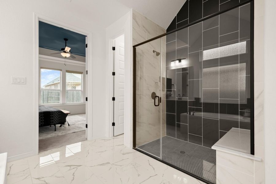 Also enjoy a large frameless glass walk-in shower with designer tile surround and bench seating. Also enjoy a large frameless glass walk-in shower with designer tile surround and bench seating.