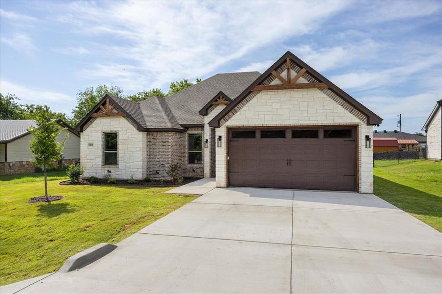 Front exterior of a new home in , Granbury, TX, highlighting curb appeal (Image 18). Front exterior of a new home in , Granbury, TX, highlighting curb appeal (Image 18).