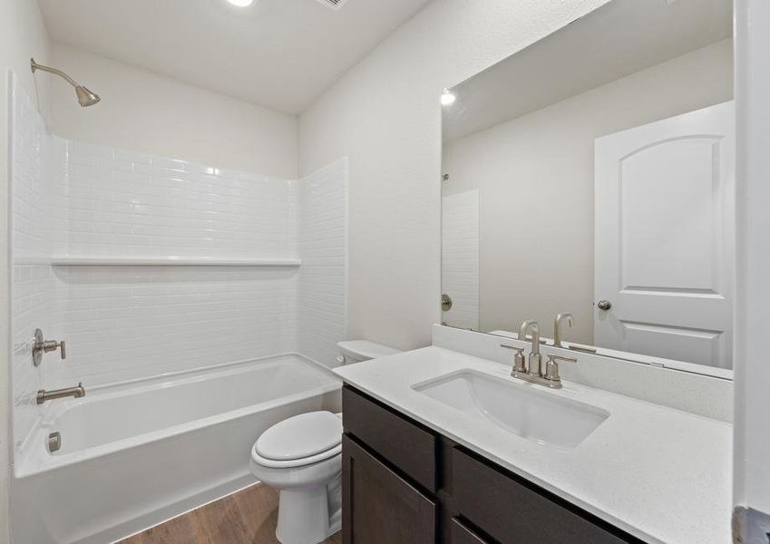 The secondary bathroom of the Colorado has a large vanity space and a shower-tub combo.