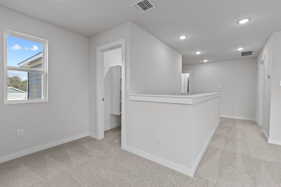 A room with a white cabinet and a window. A room with a white cabinet and a window.